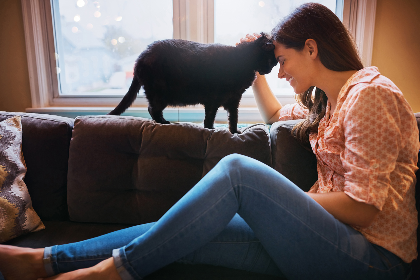 Image of woman and cat petting and nuzzling happy